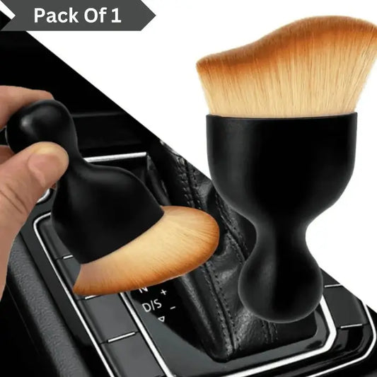 Best Car Dust Brush with black handle and wooden bristles on a car gear shift.