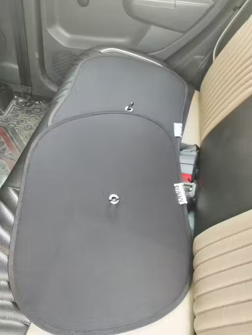 Window Sun Shade Gray car seat cover on a car seat with visible branding