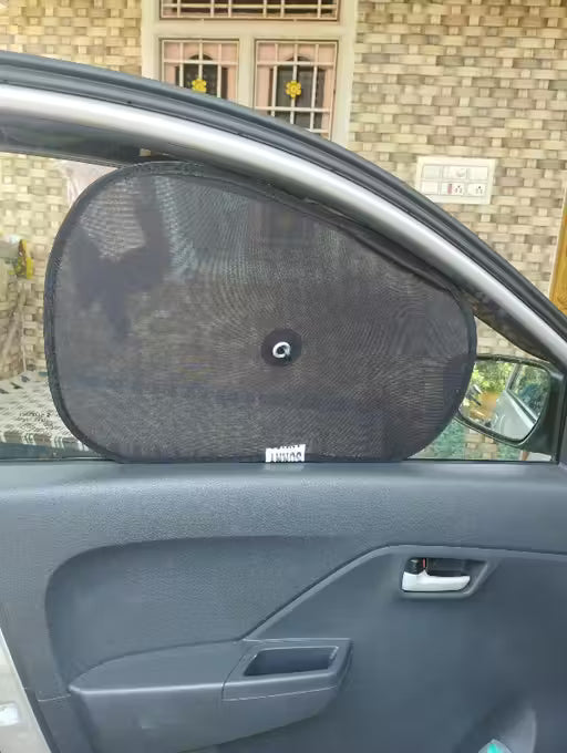 Window Sun ShadeCar side mirror with a sunshade attached, set against a brick wall background.