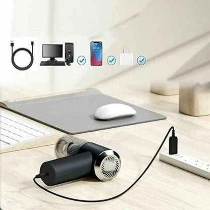 3-in-1 Car Vacuum Cleaner-Black handheld device with charging cable on a desk with electronic devices in the background