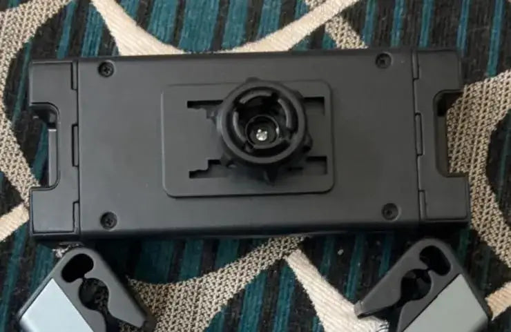 Car Tablet Holder -Black electronic component on a textured fabric background