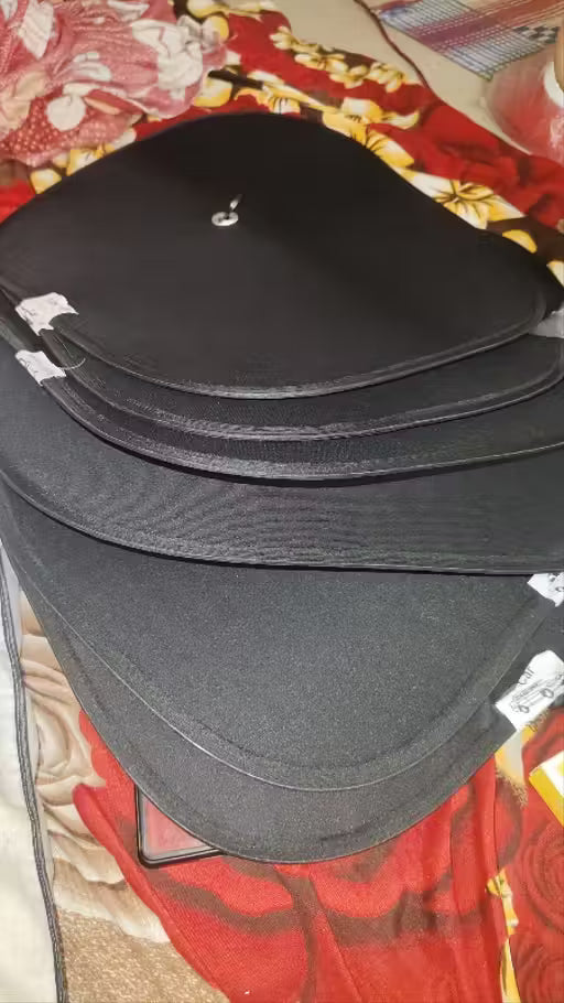 Window Sun Shade-Stack of black leather-bound books on a patterned fabric background