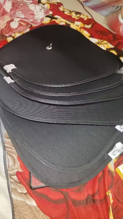 Window Sun Shade-Stack of black leather-bound books on a patterned fabric background