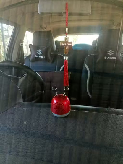 Mini Robot Car Perfume-Red car hanging ornament with cross on a car seat inside a vehicle.