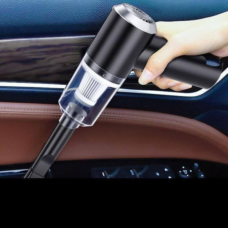 3-in-1 Car Vacuum Cleaner-Hand holding a black car vacuum cleaner inside a vehicle.