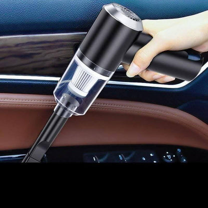 3-in-1 Car Vacuum Cleaner-Hand holding a black car vacuum cleaner inside a vehicle.