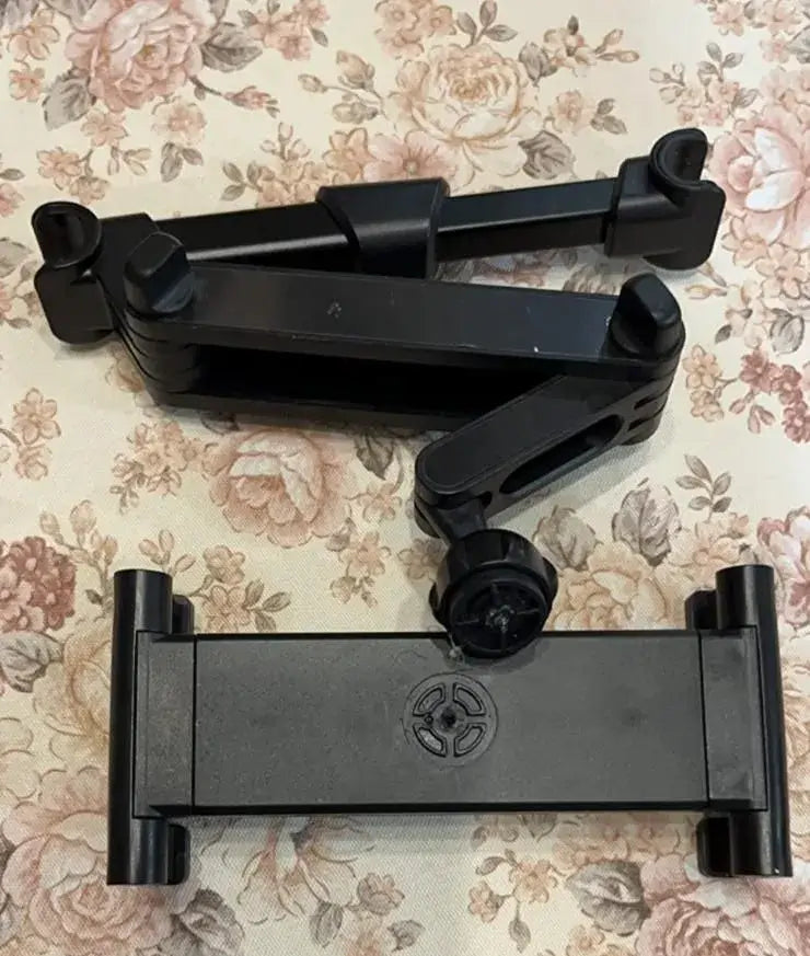 Car Tablet Holder -Black adjustable stand on a floral-patterned surface