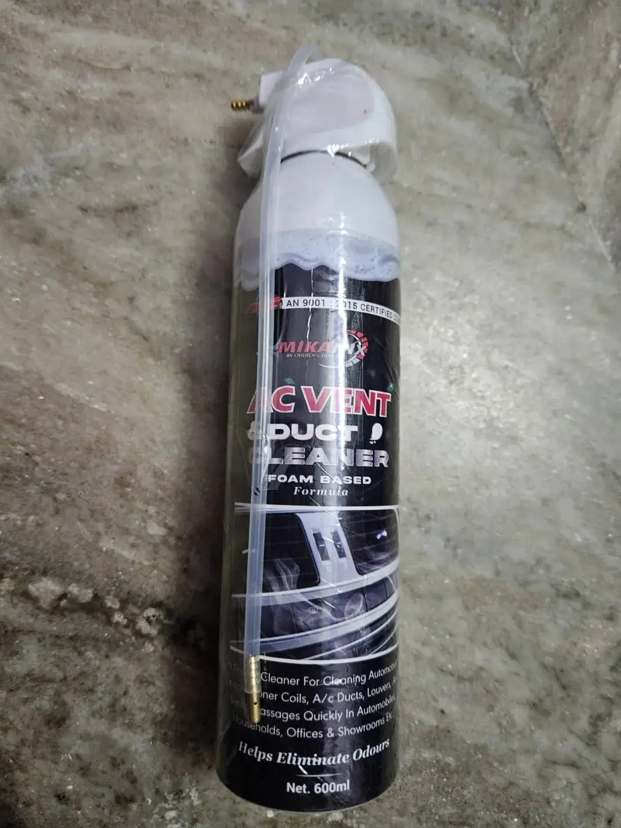 A can of duct cleaner on a concrete floor