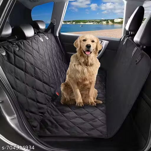 Dog sitting on a black car seat cover with a view of a beach through the car window.