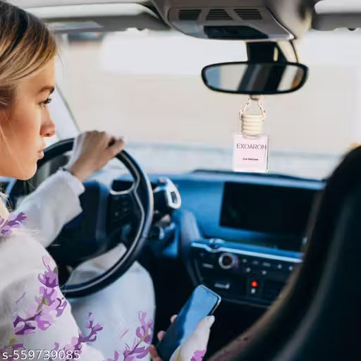 Car Perfume Diffuser-Woman driving a car with an EXOROM car air freshener hanging from the rearview mirror.
