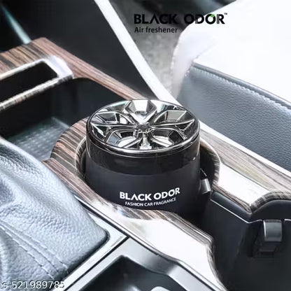 Car air freshener with 'Black Odor' branding inside a vehicle.